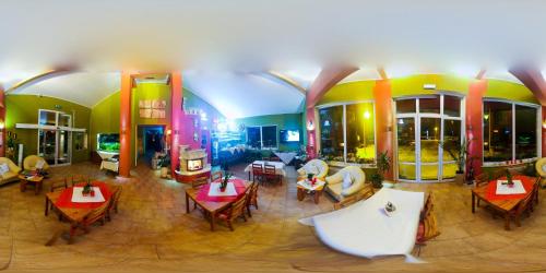 a restaurant with tables and chairs in a building at Hotel Krak in Myślenice