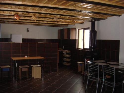 a room with tables and chairs and a window at Cabana Ada 1 in Vartop