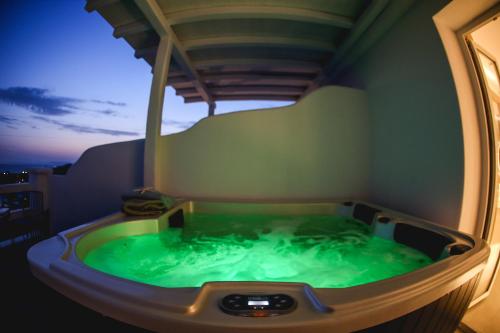 a jacuzzi tub in the middle of a room at Villa Elina suites and more in Agios Stefanos