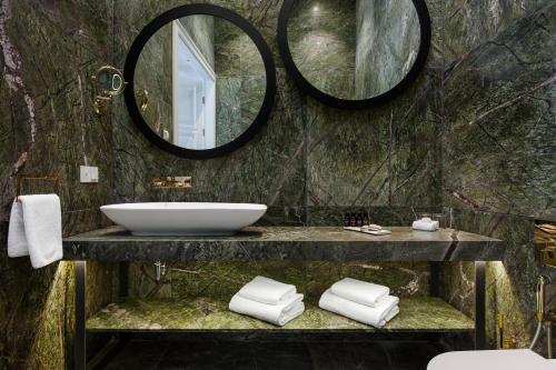 a bathroom with a sink and a mirror at Hotel Pacai, Vilnius, a Member of Design Hotels in Vilnius