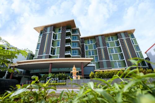 a large building with blue windows at Clover Hotel Hatyai in Hat Yai