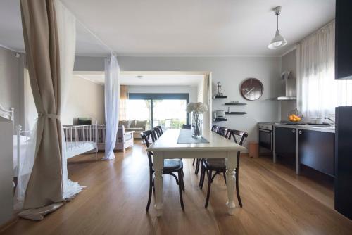 a kitchen and dining room with a table and chairs at #Luxlikehome - Tessi's House in Nea Kalikratia
