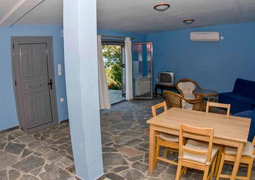 a living room with a wooden table and chairs at Periyali in Keratea