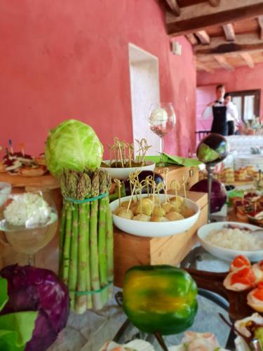 a table with vegetables and other foods on it at I giardini segreti di Villa Marcello Marinelli in Cison di Valmarino
