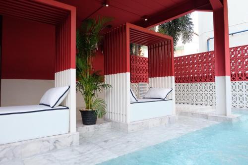 a resort with two chairs and a swimming pool at Talakkia Boutique Hotel in Bangkok