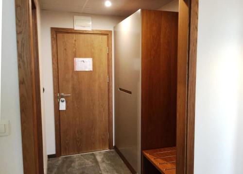 a hallway with a wooden door in a room at Hotel Golden Tulip Varna in Varna City