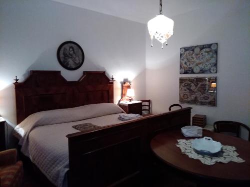 - une chambre avec un lit, une table et un lustre dans l'établissement Sot la Cleva, à Socchieve