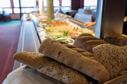a group of breads on a display in a buffet at Revsnes Hotel in Byglandsfjord