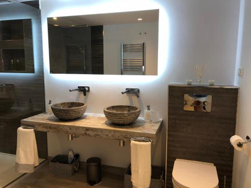 a bathroom with two sinks and a mirror at Luxury apartment in La Isla, Puerto Banus in Marbella