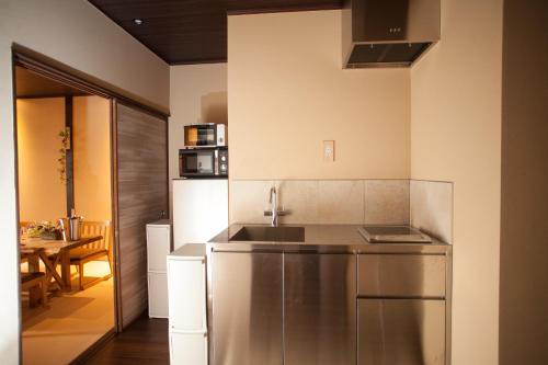 a kitchen with a sink and a counter top at Oyama TABI-NE in Kanazawa