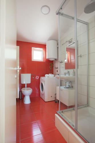 a bathroom with a toilet and a sink and a shower at Villa Stina in Baška Voda