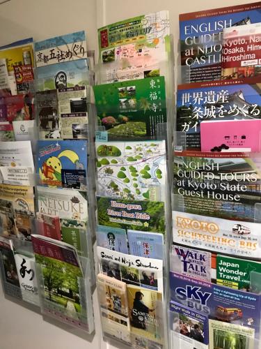 a bunch of books on display in a store at Kyoto Uraraka Guest House in Kyoto