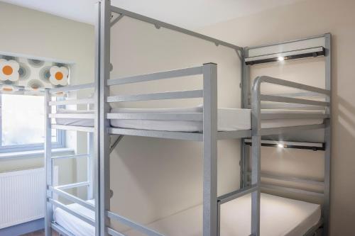 a bunk bed in a room with two bunk beds at Wild Atlantic Hostel in Leenaun