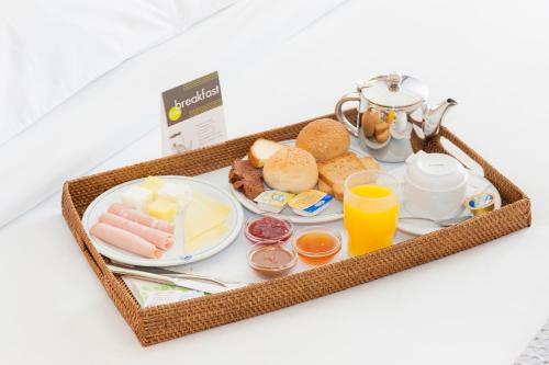 a tray of breakfast foods and drinks on a table at Athinais Hotel in Athens