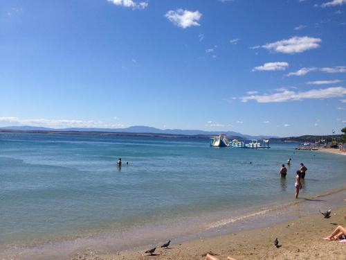 a group of people in the water at a beach at Studio Larla in Crikvenica