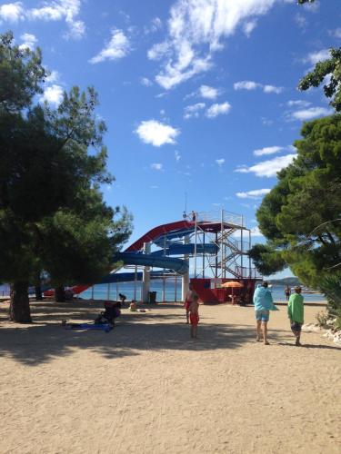 a group of people walking on the beach at Studio Larla in Crikvenica