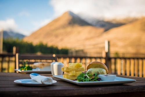 a plate of food on a wooden table at Wild Atlantic Hostel in Leenaun