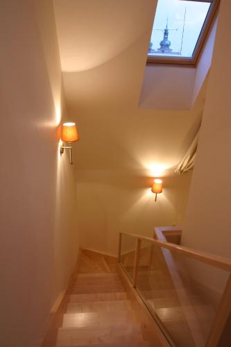 a stairway with two lights and a window at Ventana Hotel Prague in Prague