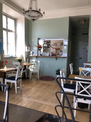 a kitchen with a table, chairs and a refrigerator at Dockside Hostel Old Town in Stockholm