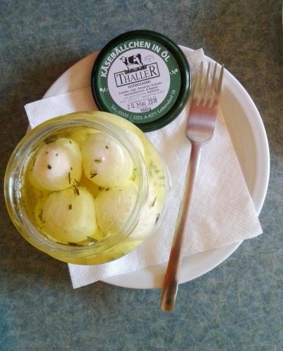 a jar of mashed potatoes and a fork on a plate at Gästehaus Nora in Stein bei Loipersdof