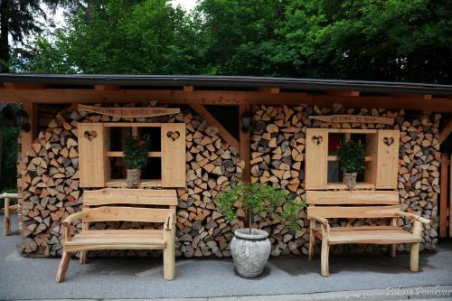 a wooden cabin with two chairs and two windows at Ribno Alpine Hotel in Bled