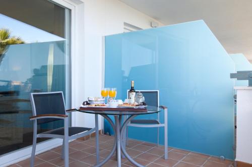 a dining room with a table and two chairs at Senator Banus in Estepona