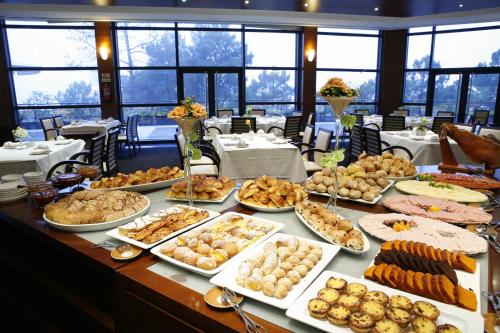 a table with many different types of food on it at Montebelo Viseu Congress Hotel & Spa in Viseu