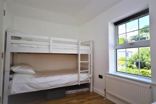 Voodi või voodid majutusasutuse Pebble Cottage toas