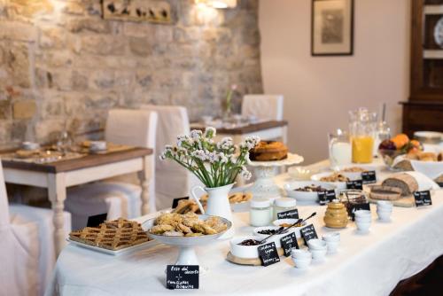 a table with desserts and pastries on it at Torre di Badia in Badia A Passignano