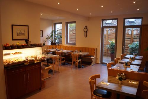 a restaurant with tables and chairs in a room at Pension am Heusteig in Stuttgart