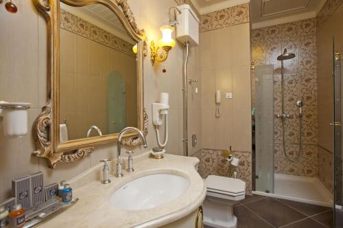 a bathroom with a sink and a shower at Limak Thermal Boutique Hotel in Gokcedere