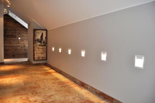 an empty room with a wall with a painting on it at StrandBerg's Designhotel Viktoria in Braunlage