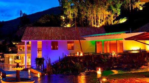 a house lit up at night with lights at Aranwa Pueblito Encantado del Colca in Coporaque