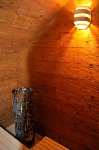 a room with a wooden wall with a lamp at StrandBerg's Designhotel Viktoria in Braunlage