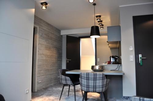 a kitchen and dining room with a table and chairs at StrandBerg's Designhotel Viktoria in Braunlage