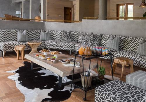 a living room with a table with food on it at Lush Private Game Lodge in Pilanesberg