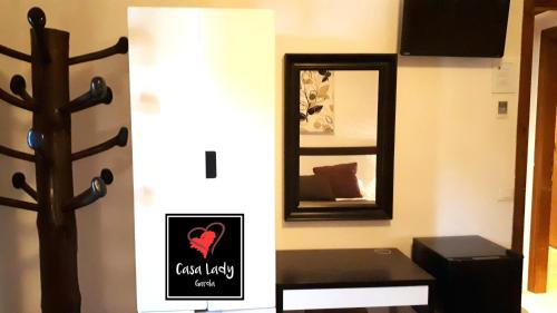 a room with a mirror and a bench and a sign at Casa Lady in Garda