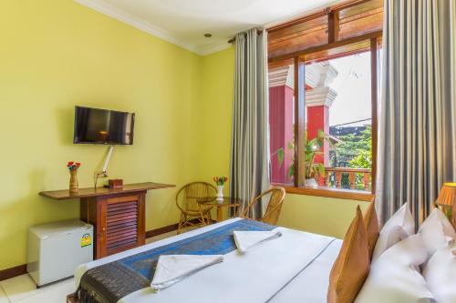 a bedroom with a bed and a window at Side Walk Hotel in Siem Reap