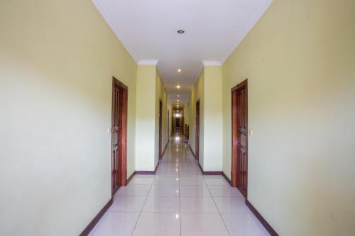 a corridor of a building with yellow walls and white walls at Side Walk Hotel in Siem Reap