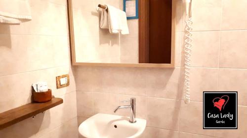a bathroom with a sink and a mirror at Casa Lady in Garda