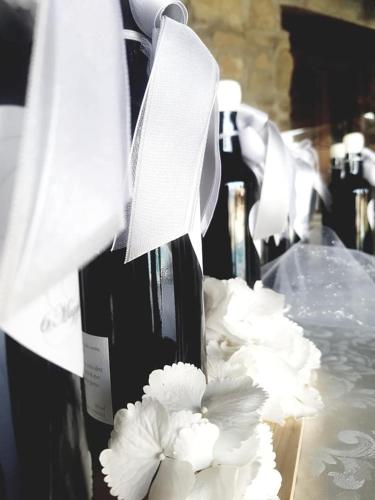 a group of bottles of wine with white flowers at Grand Relais Laurenti in Gualdo Cattaneo