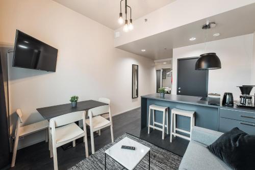 a living room with a table and a kitchen at Forenom Aparthotel Vantaa Tikkurila in Vantaa