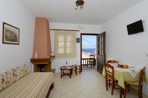 a living room with a couch and a table at Achinos Apartments and Maisonettes in Kokkari