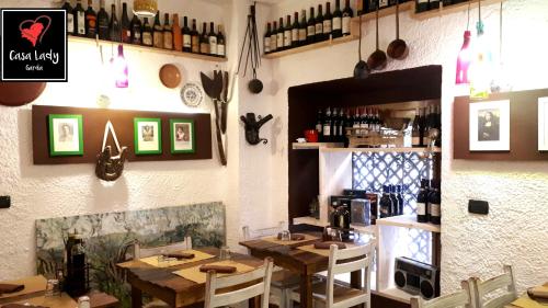 a restaurant with tables and chairs in a room at Casa Lady in Garda