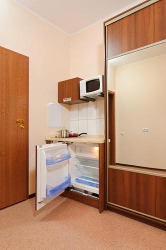 an empty refrigerator with its door open in a room at Lukyanovsky in Kyiv