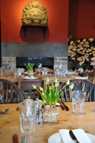 a table in a restaurant with a wooden table with glasses at The Red Lion Inn in Babcary