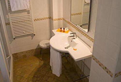a bathroom with a white sink and a mirror at JR Resort Logos Forte dei Marmi in Forte dei Marmi
