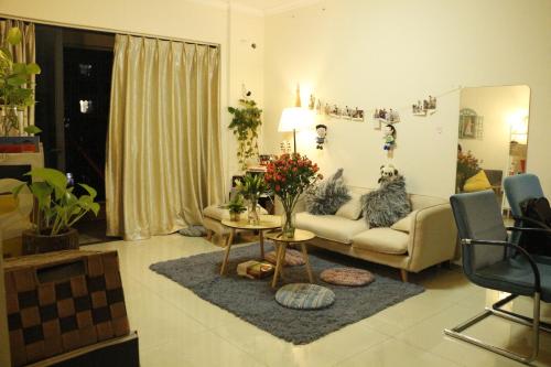 a living room with a couch and a table at Lan House Youth Apartment in Guangzhou