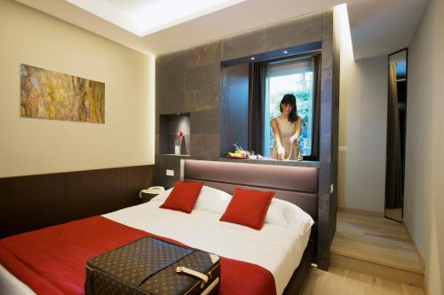 A bed or beds in a room at UNAHOTELS Villa dei Platani Foligno