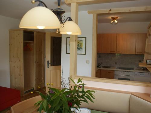 a kitchen with a table and a large mirror at Biobauernhof Nussbaumer in Nussdorf am Attersee